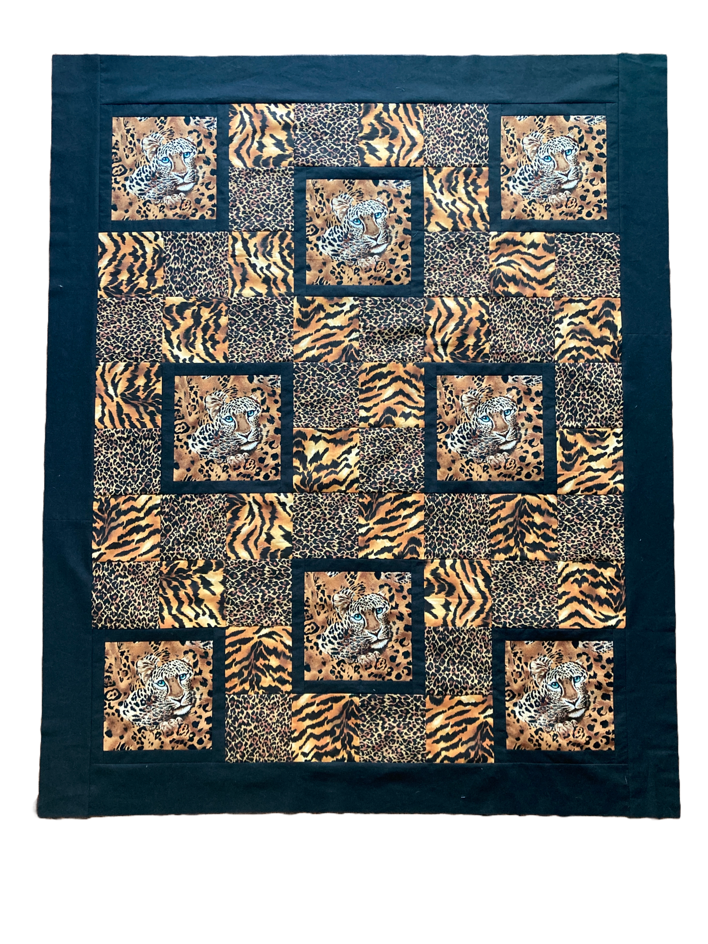 Portrait Mode quilt in leopard and tiger with leopard faces.