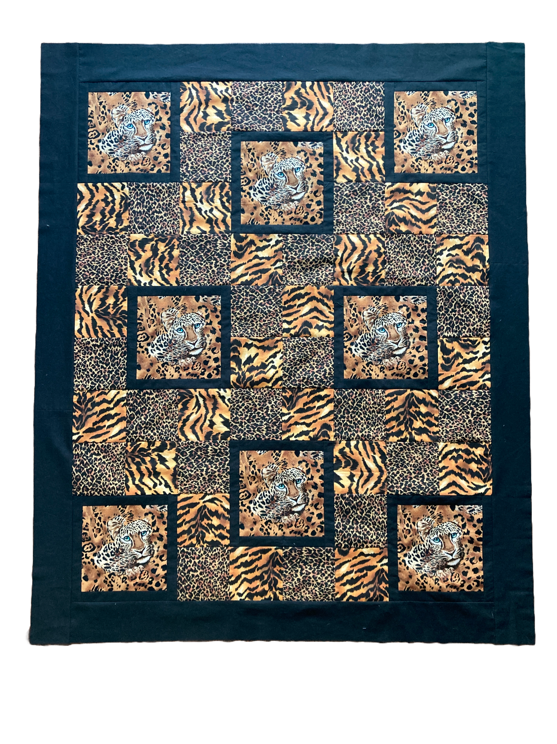 Portrait Mode quilt in leopard and tiger with leopard faces.