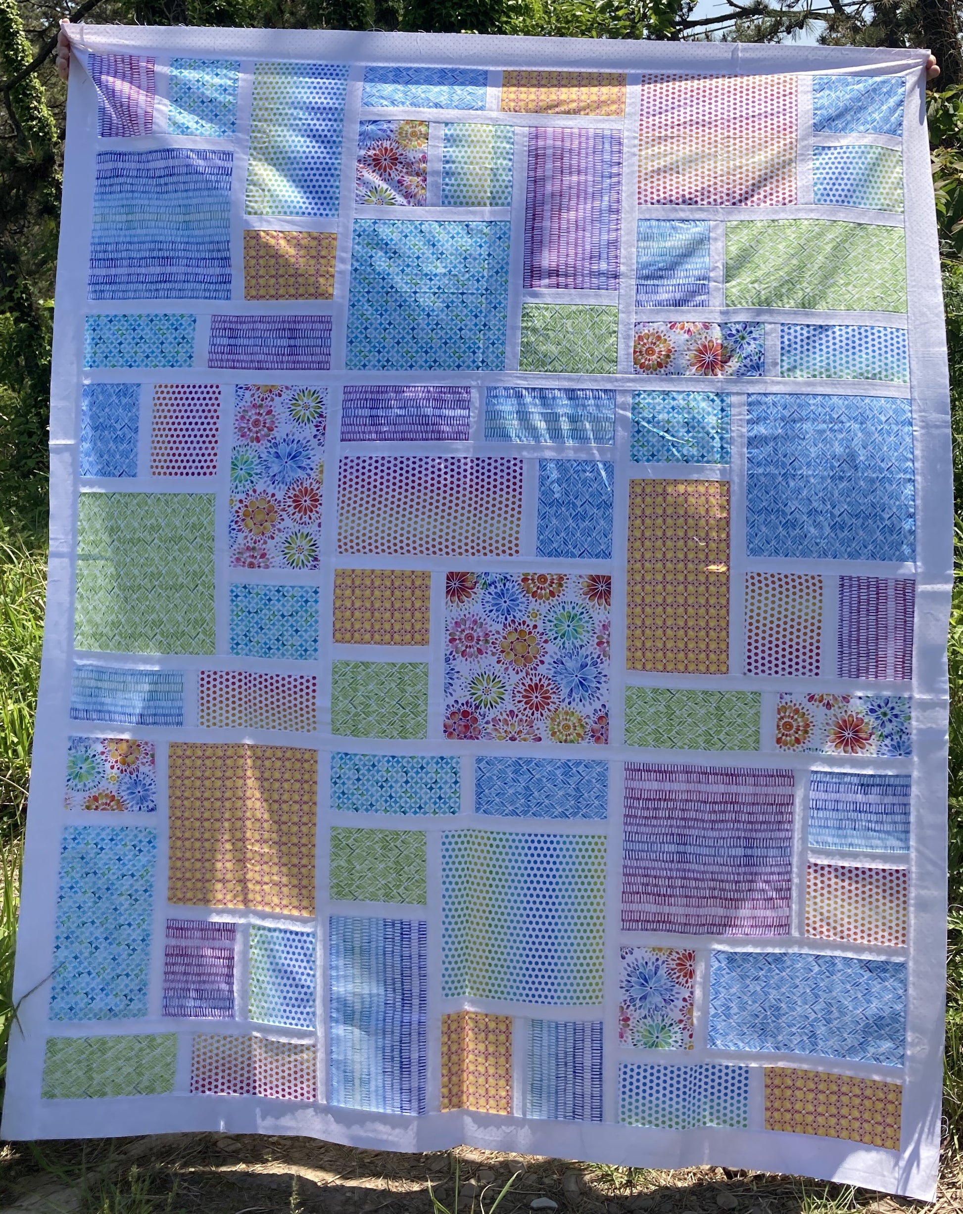 Slea Head Quilt, Throw size in rainbow and white.